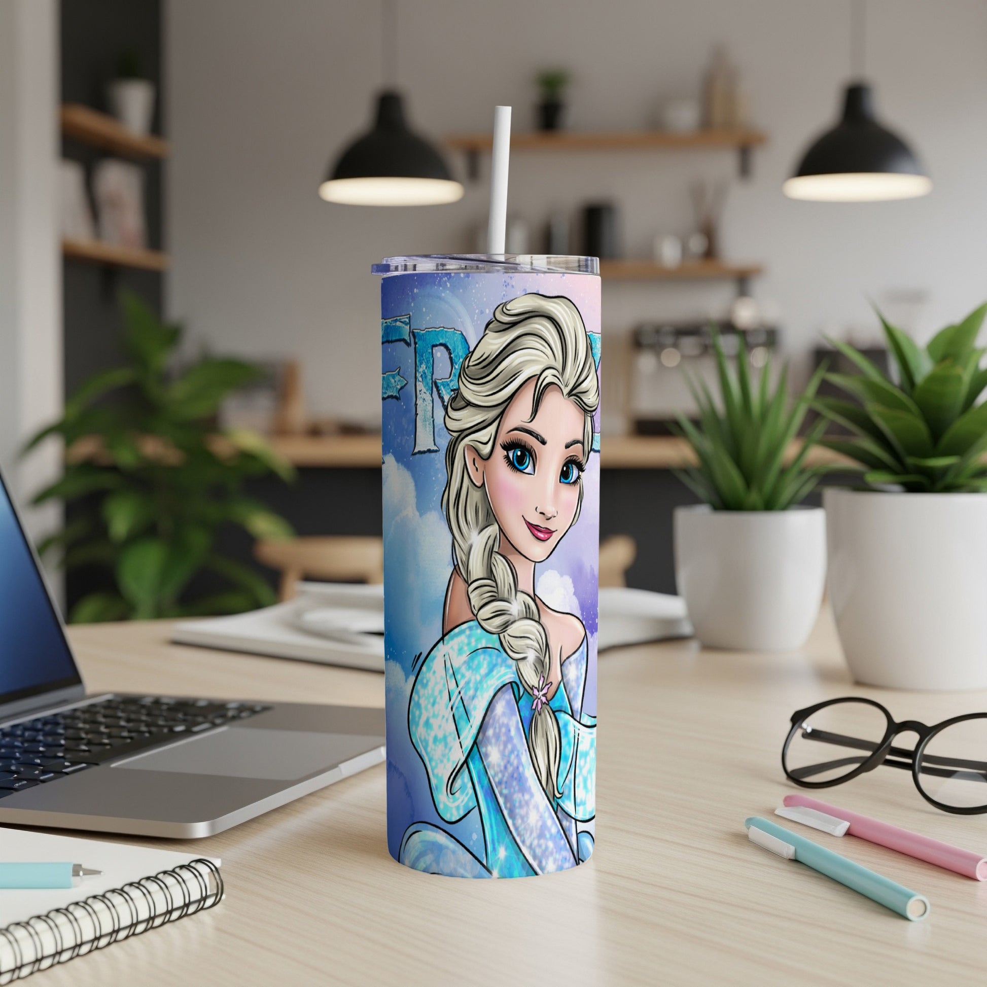 Frozen Elsa character on a blue ombre tumbler with white straw on a desk.