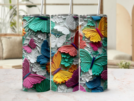 Tumbling butterflies adorn a colorful tumbler with a straw.
