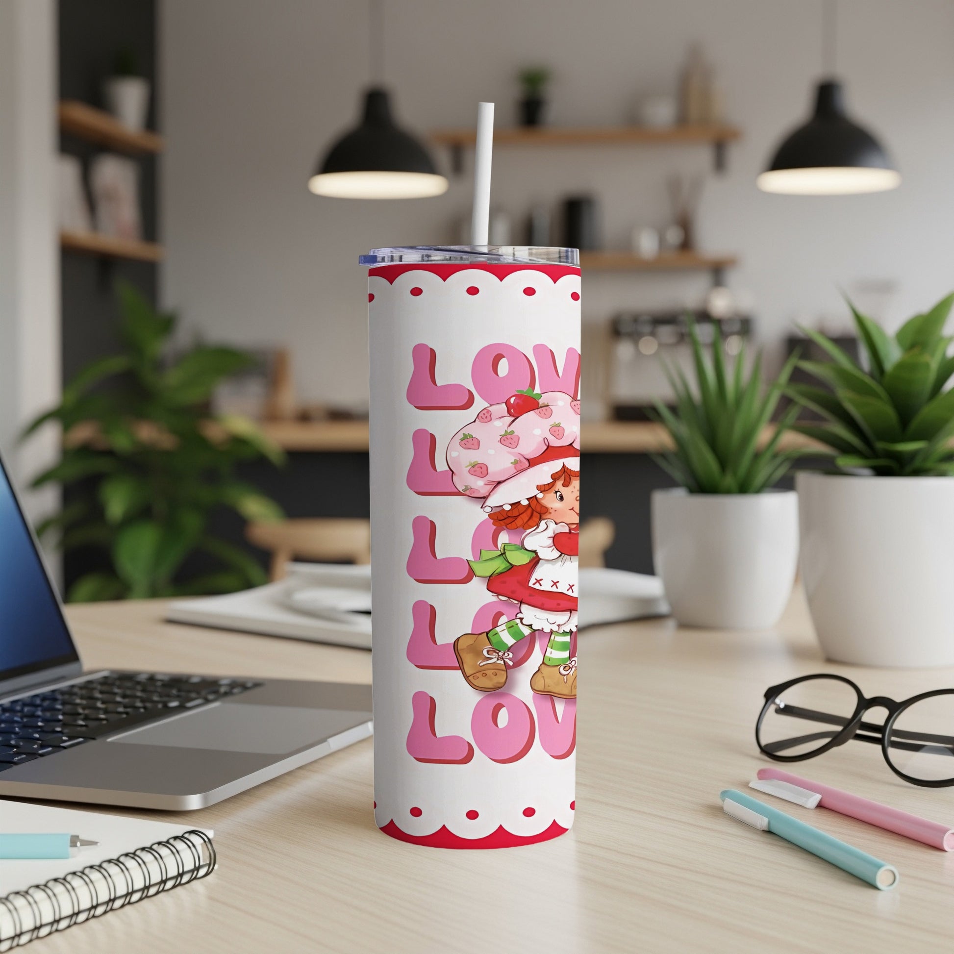 Strawberry Shortcake pattern on a white tumbler with a straw.