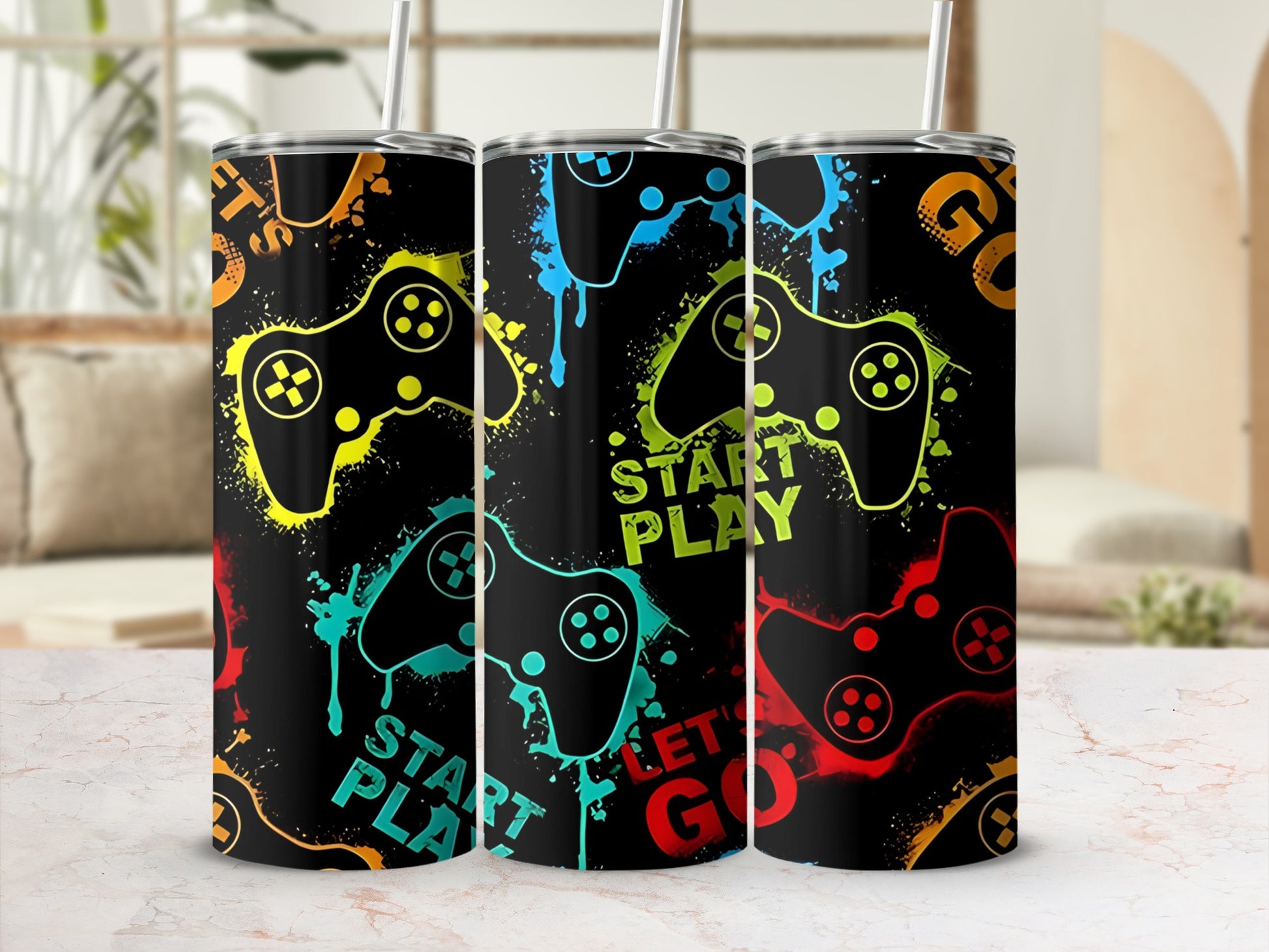 Three tumblers with a colorful video game controller design and text.