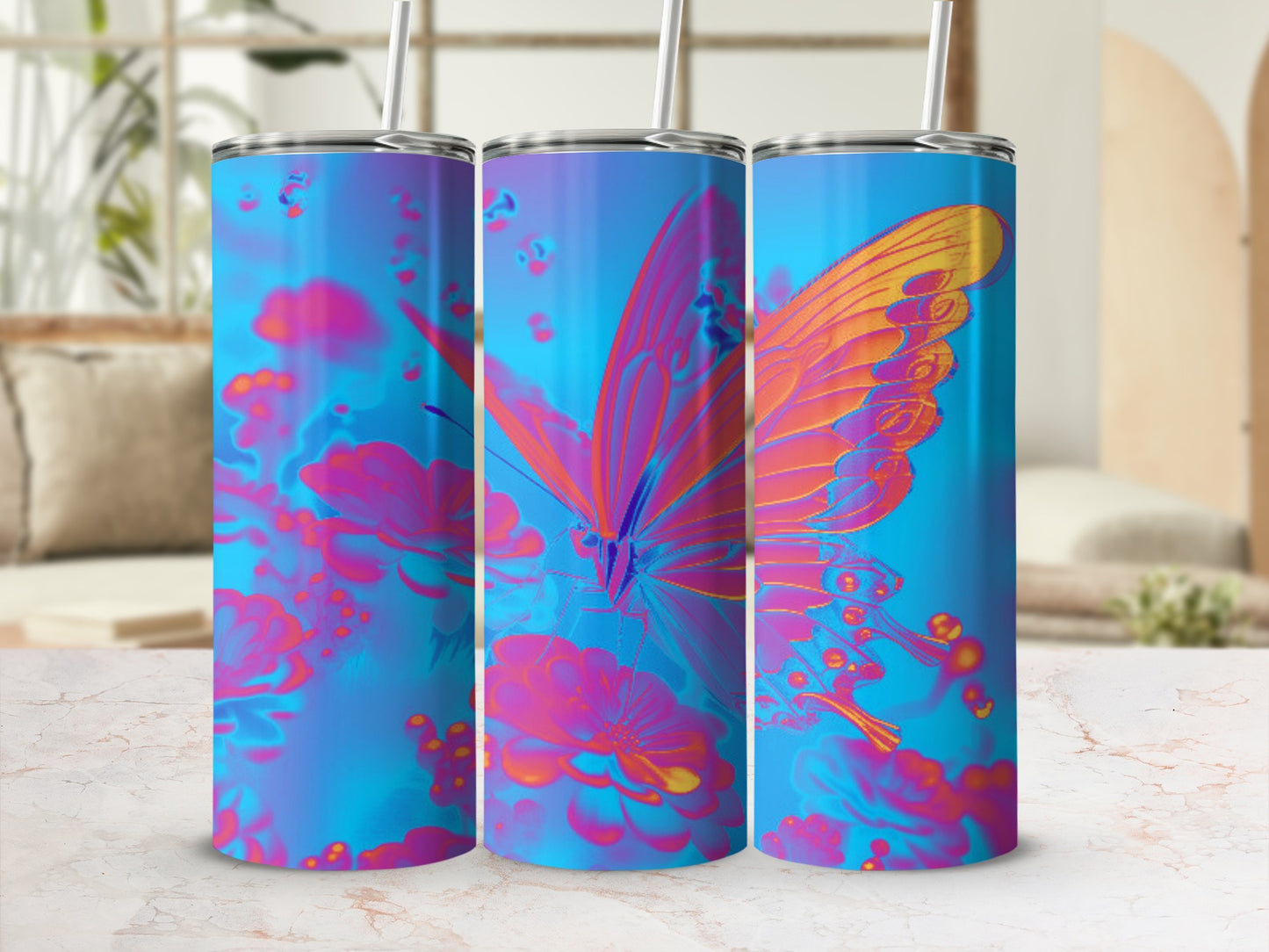 Three tumblers with a colorful butterfly and floral design on a white surface.