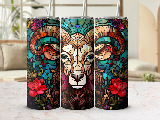 Stained glass ram head surrounded by red flowers and green foliage.