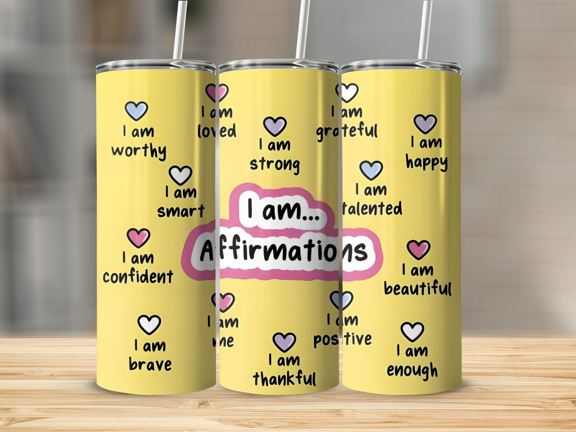 Yellow tumbler with "Affirmations" and "I am" statements in pink hearts.