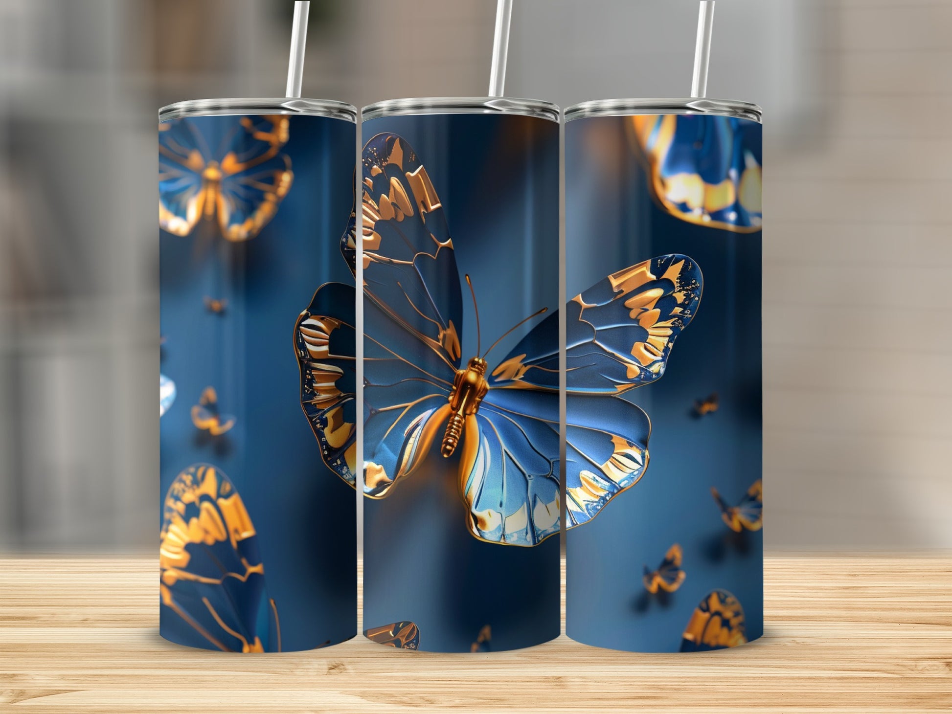 Three tumblers with detailed blue and gold butterfly designs.