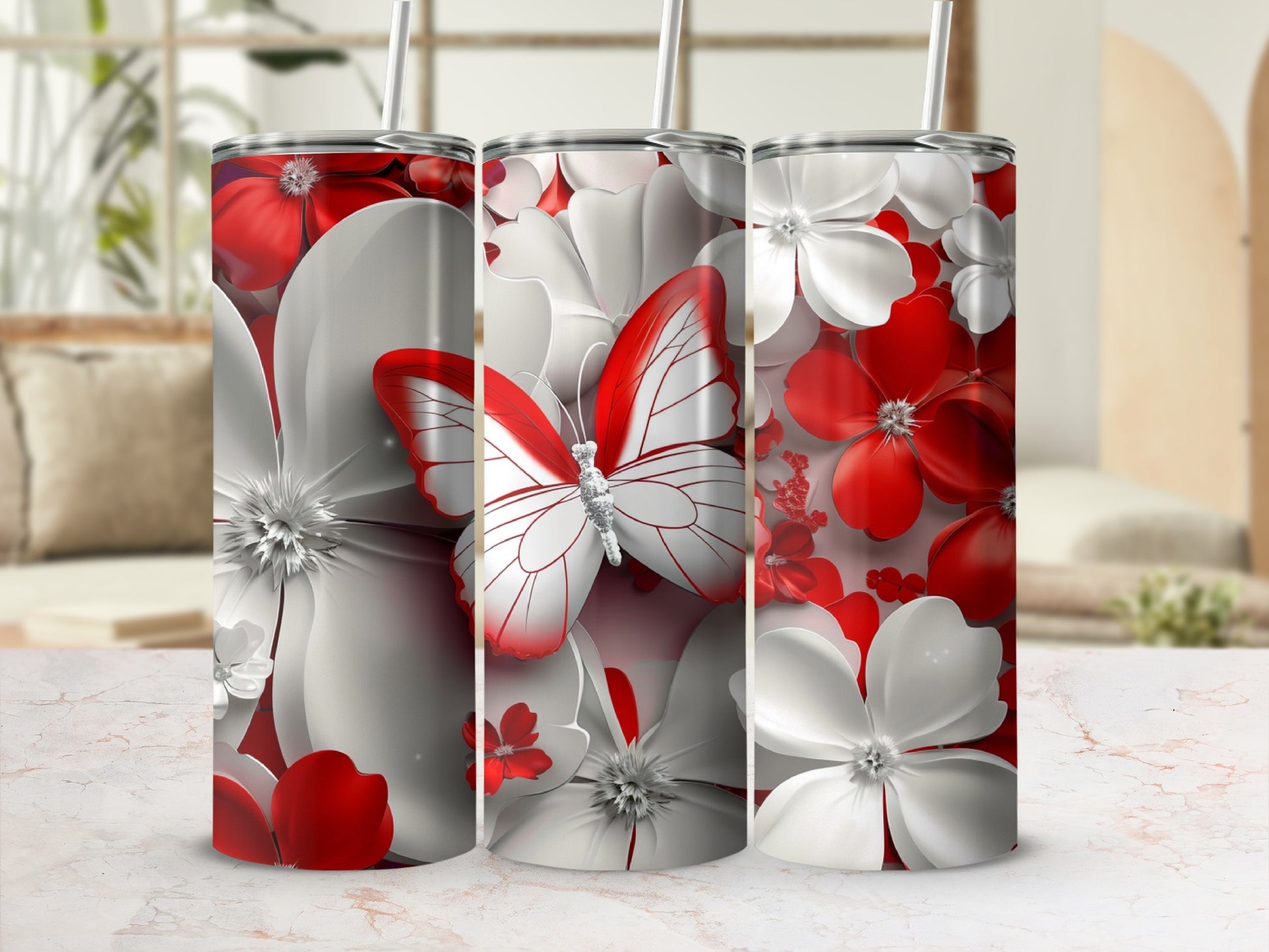 Three tumblers with red and white floral designs and a butterfly.