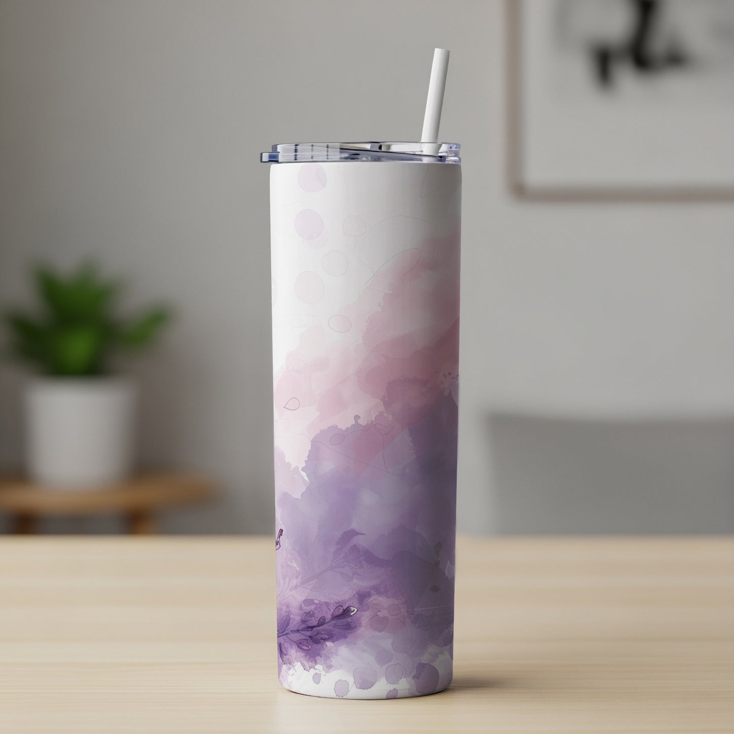 Tumbler with abstract purple and pink watercolor design and straw.
