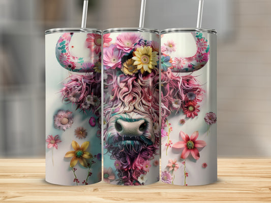 Highland cow with colorful floral mane and horns on a white tumbler.