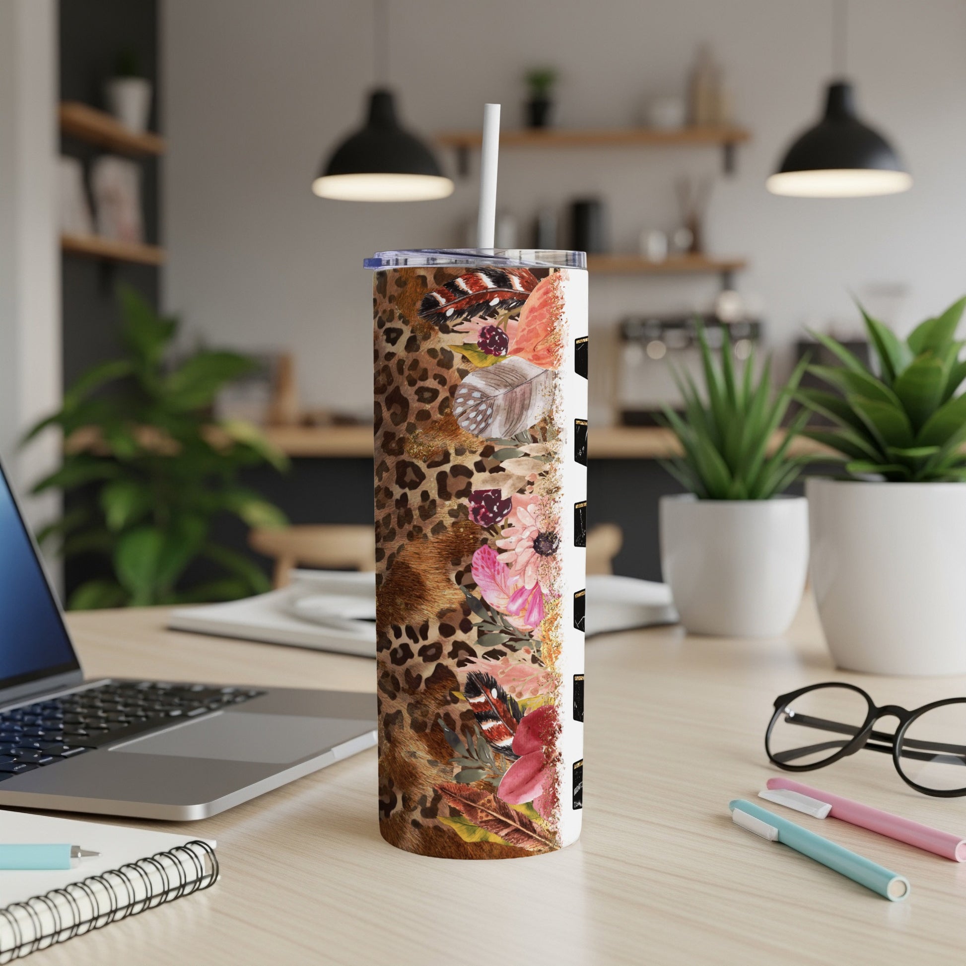 Leopard print tumbler with floral and feather accents, straw included.