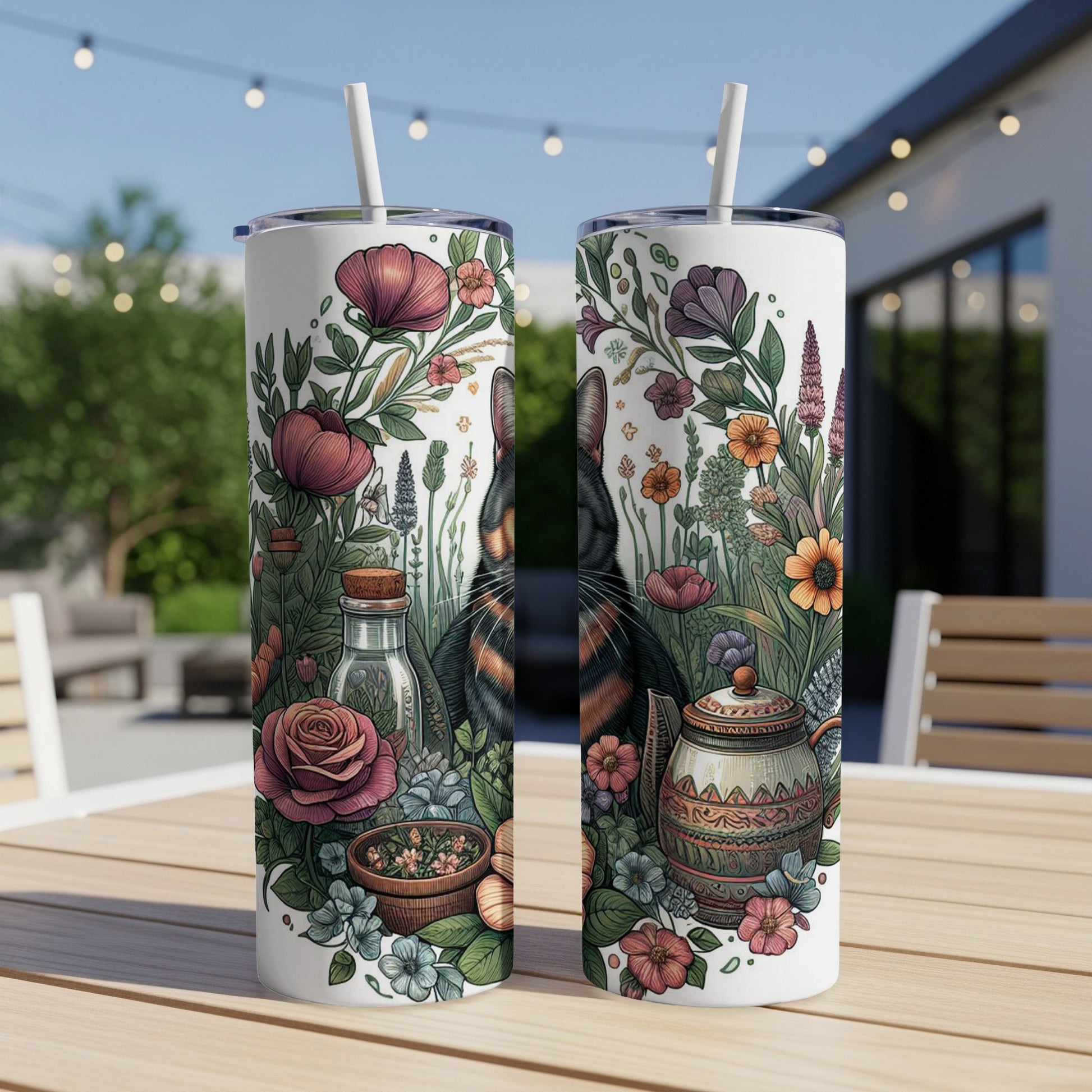 Cat among wildflowers on a floral patterned tumbler with straw.