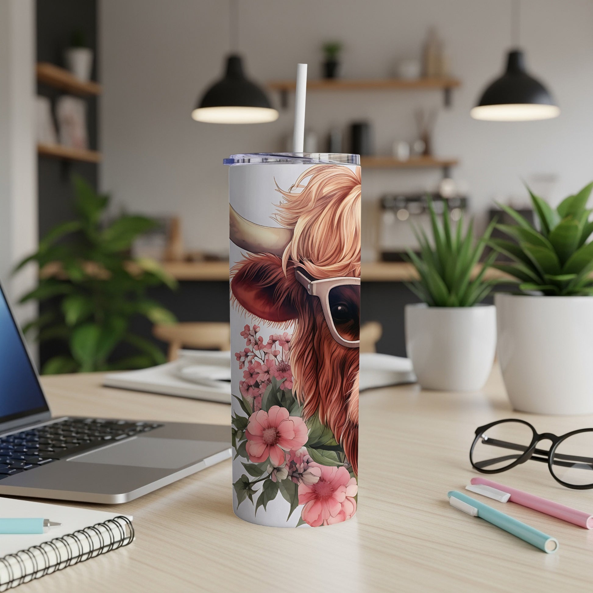 Highland cow in sunglasses on a floral-patterned tumbler with straw.