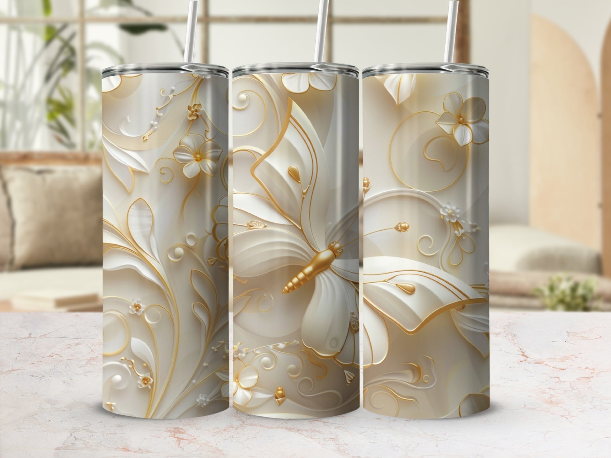 Three white tumblers with ornate gold butterfly and floral designs.