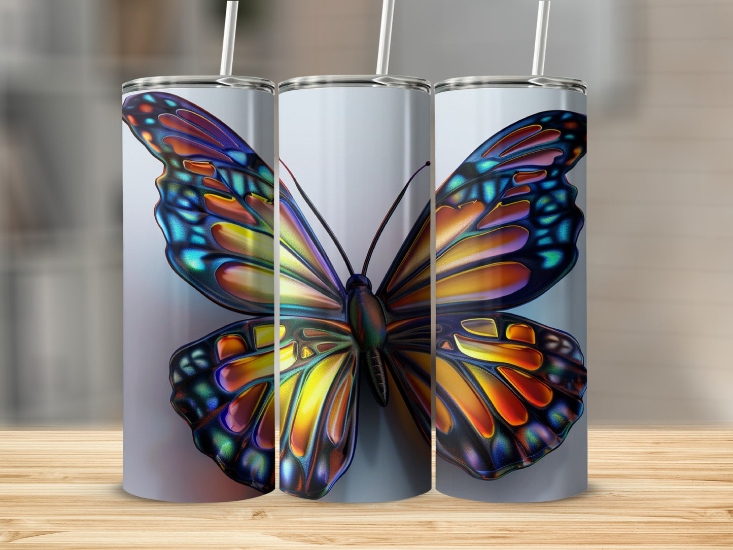 Three tumblers featuring a colorful butterfly design.
