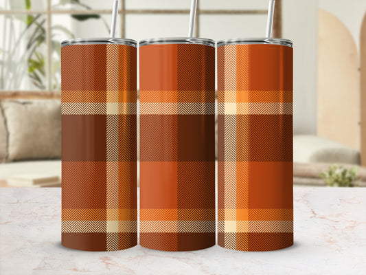 Three plaid tumblers in warm orange, brown, and cream tones.