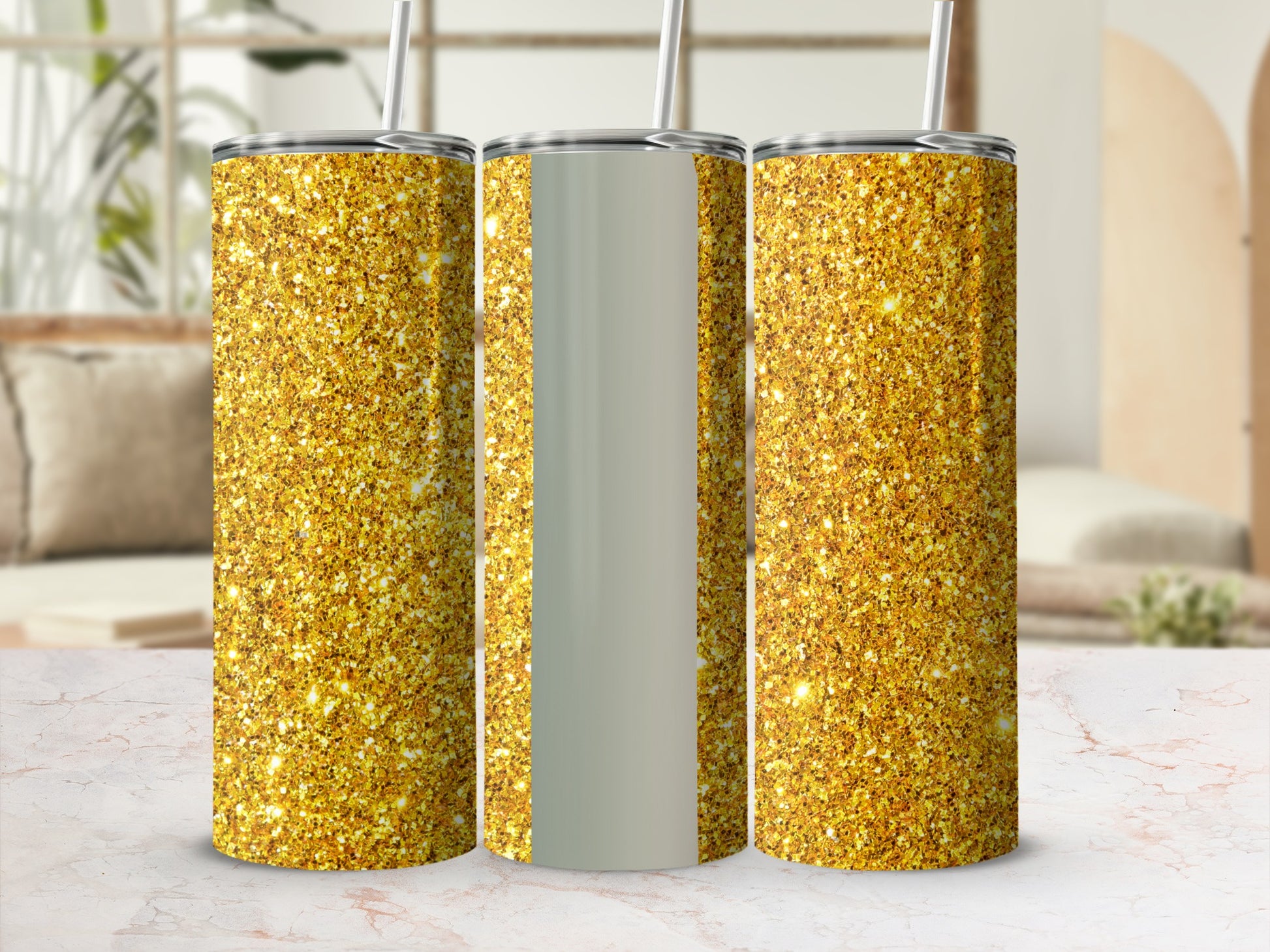 Three glitter tumblers with straws on a marble surface.