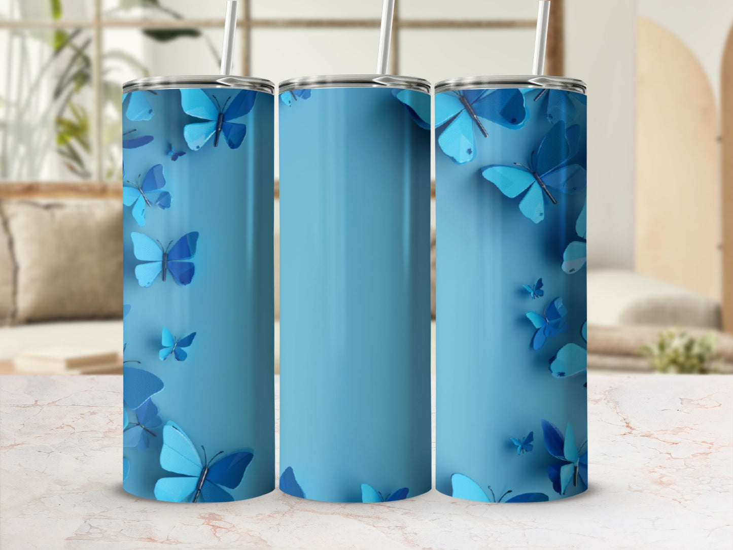 Blue tumbler with repeating butterfly pattern and straw.