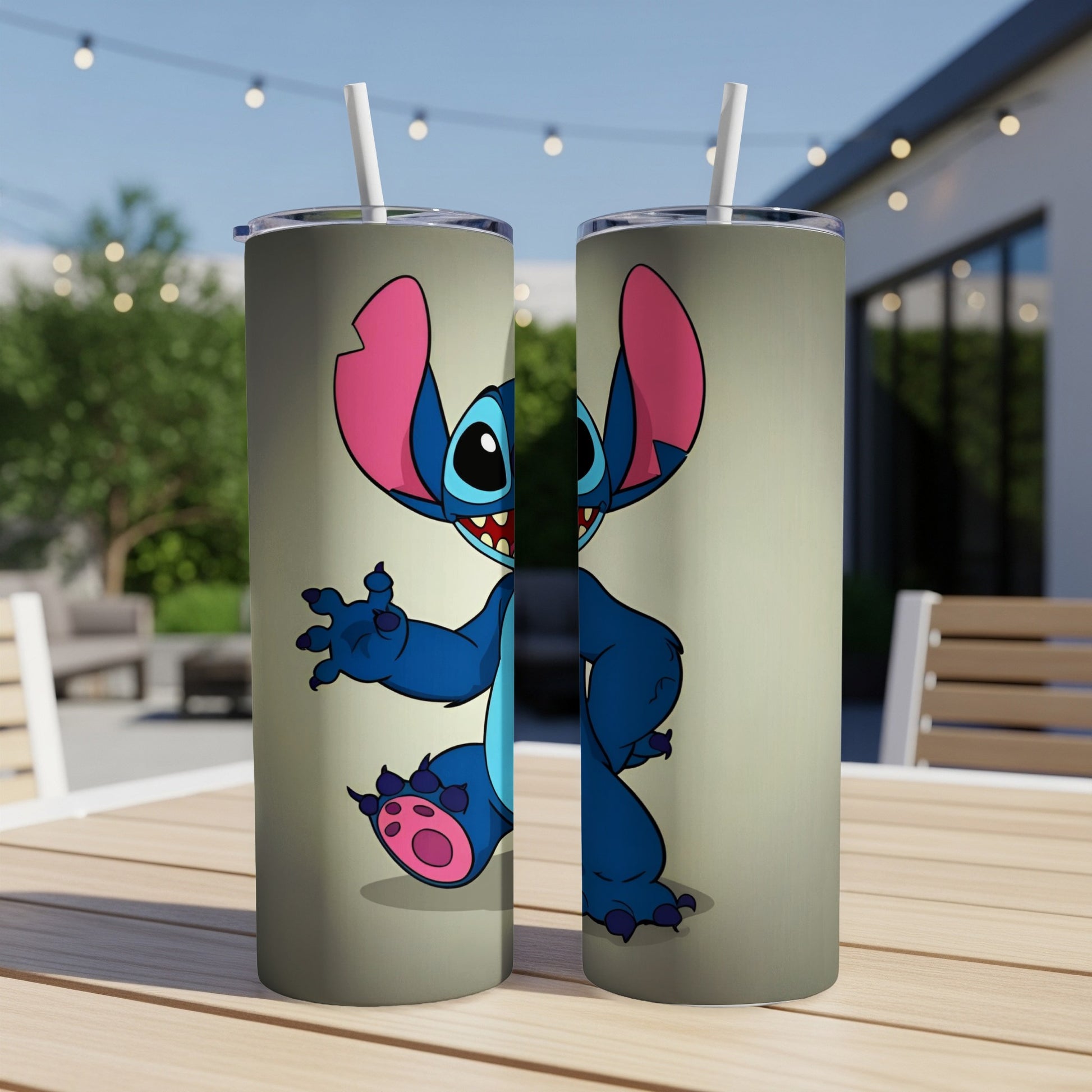 Two Stitch tumblers with straws, Stitch smiling on a light green background.