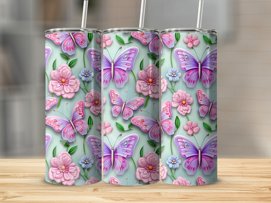 Pink and purple butterflies and flowers on a light green tumbler.