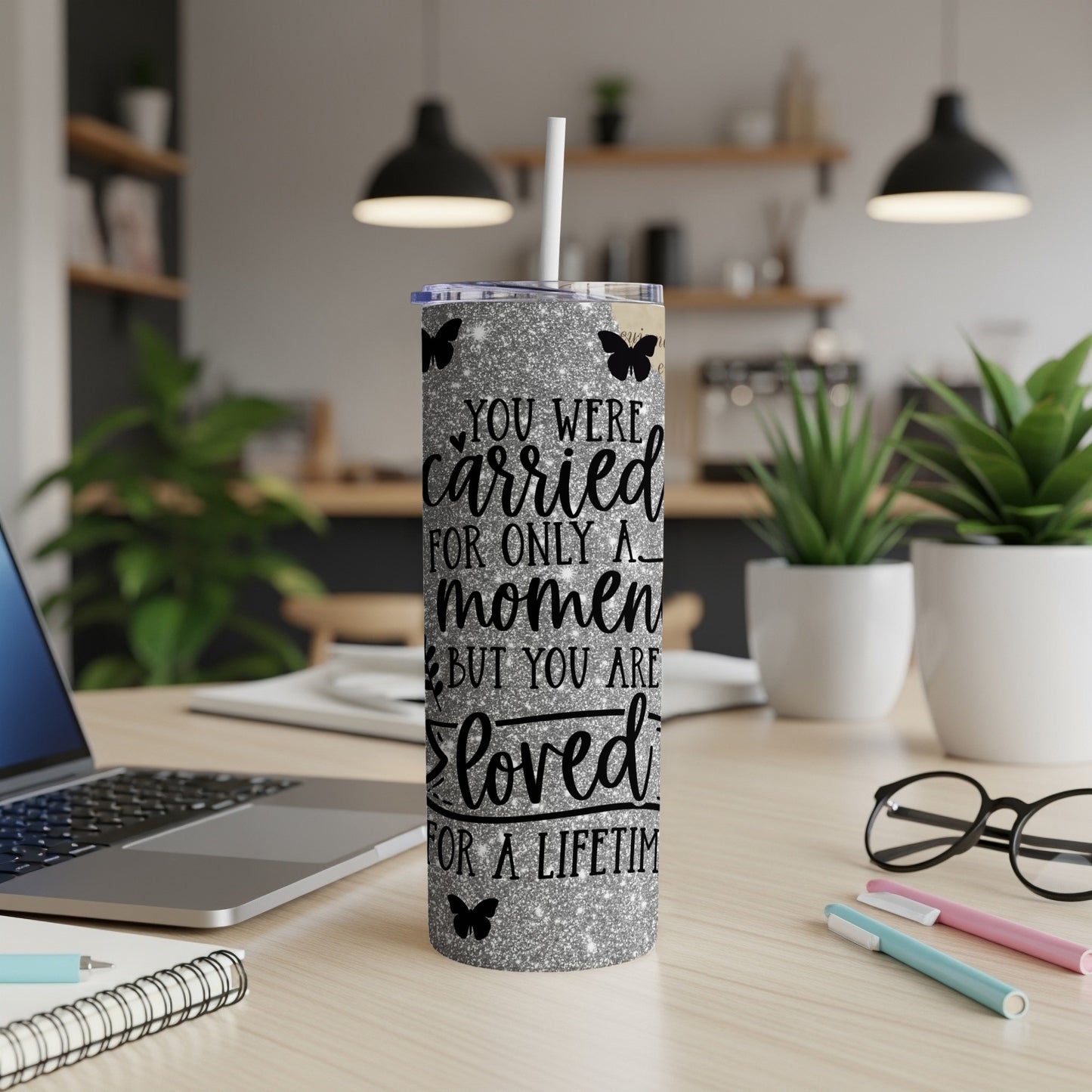 Glitter tumbler with butterflies and text: "You were carried for only a moment but you are loved for a lifetime."