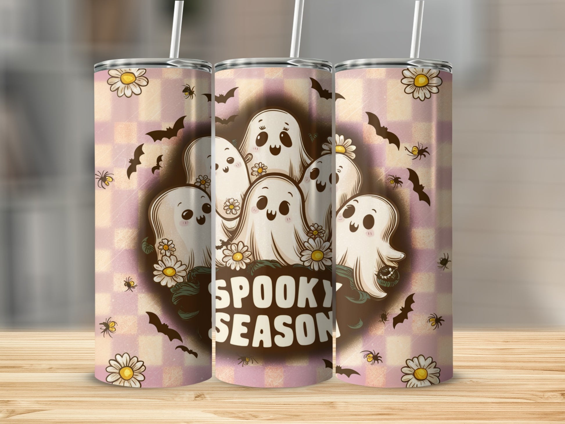 Tumbler with cute ghosts, flowers, bats, and "Spooky Season" text.