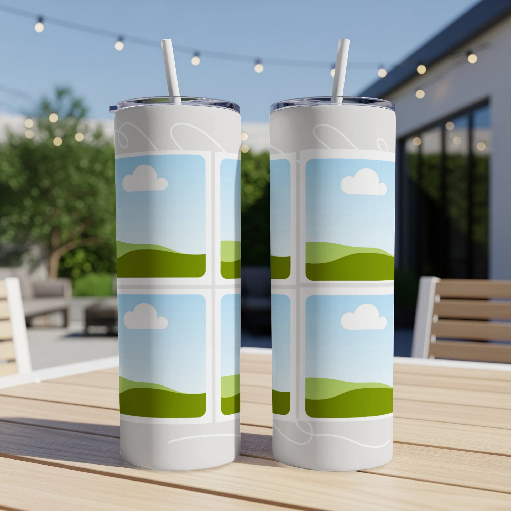 Two tumblers with a cartoon landscape pattern of clouds and hills.