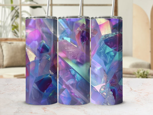 Tumbler with iridescent crystal pattern and straw, on a marble surface.
