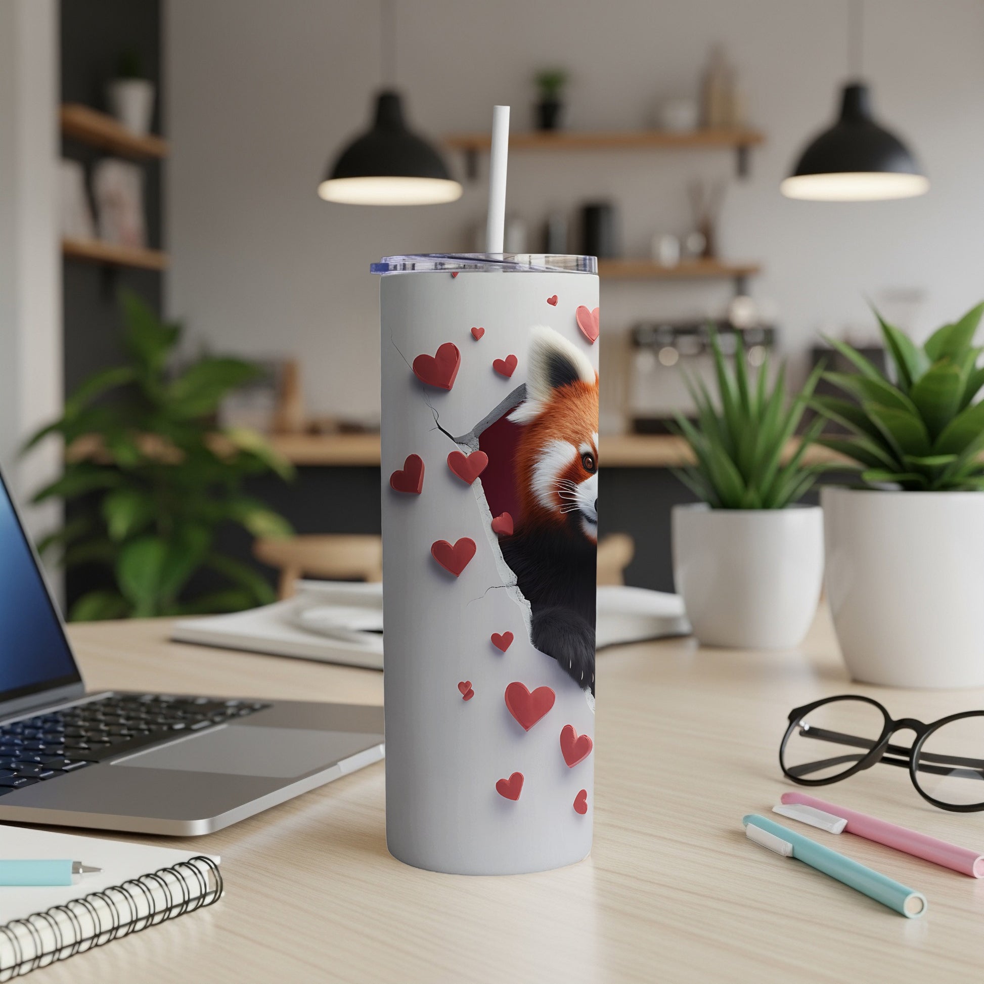 White tumbler with red panda emerging from torn heart pattern.