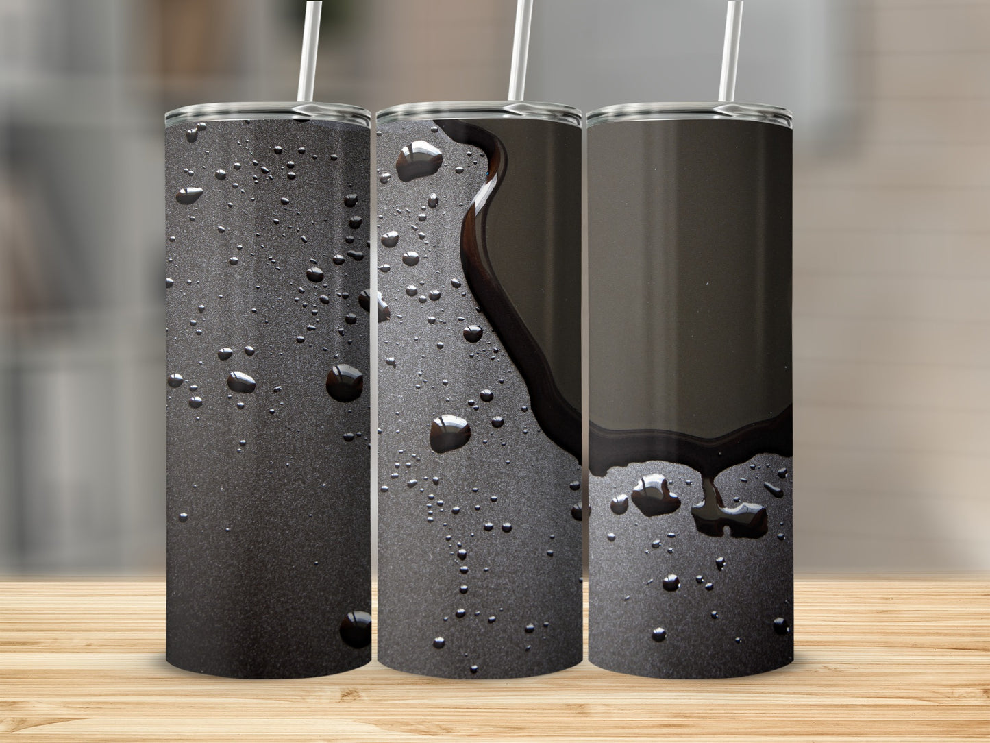 Three tumblers on a wooden surface, one with spilled dark liquid.