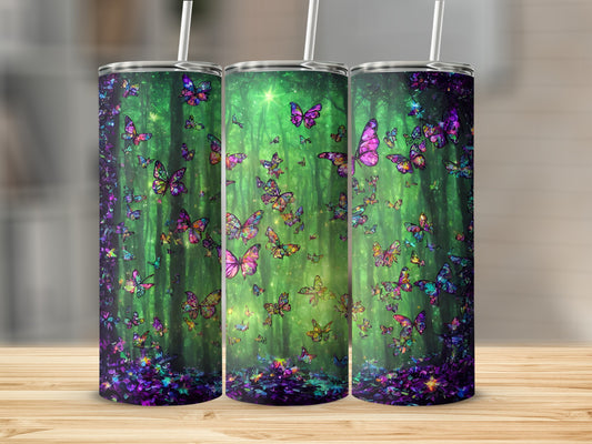Three tumblers with a vibrant, luminous butterfly forest design.