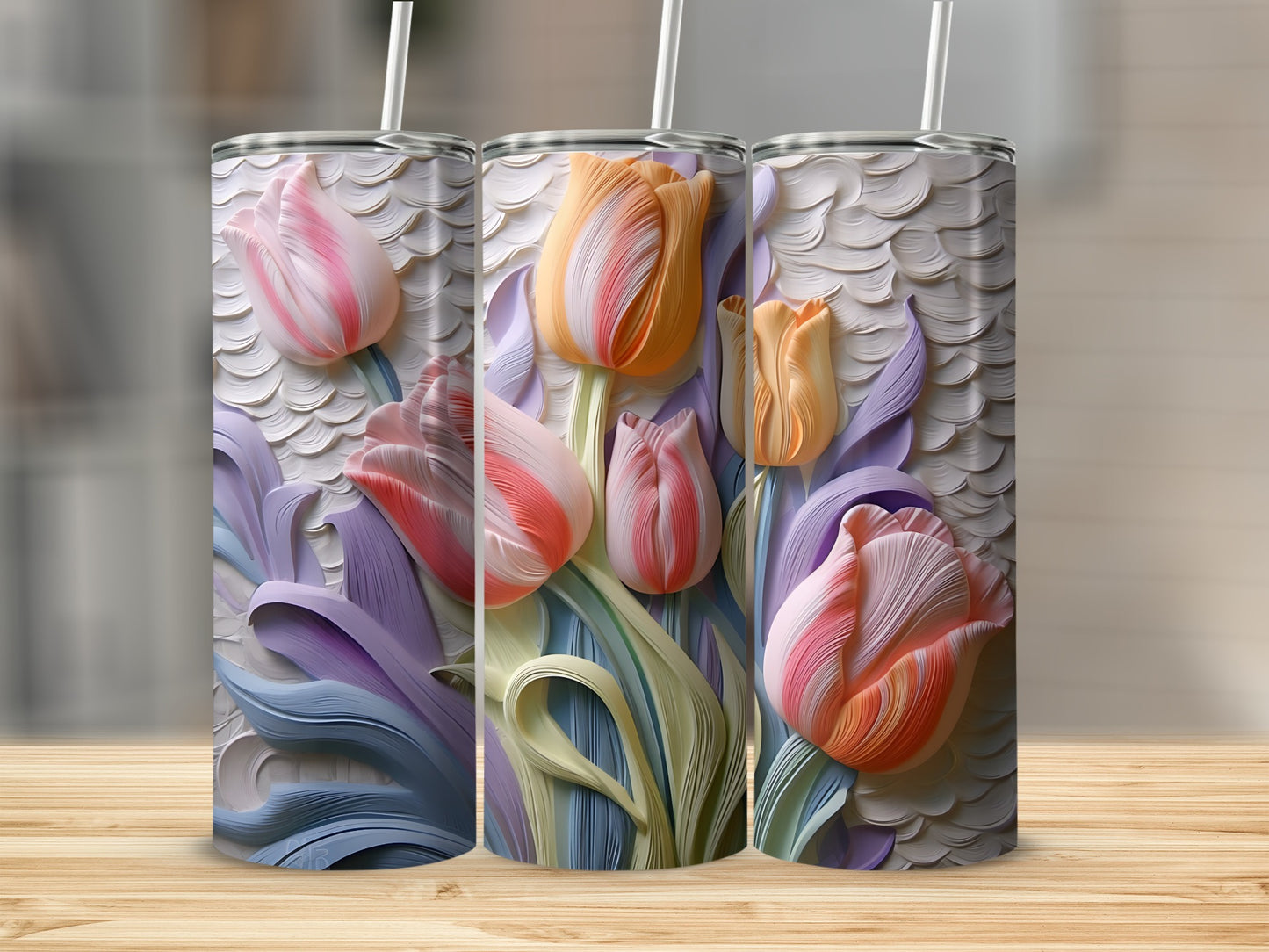 Three tumblers with embossed tulip floral designs in pastel colors.