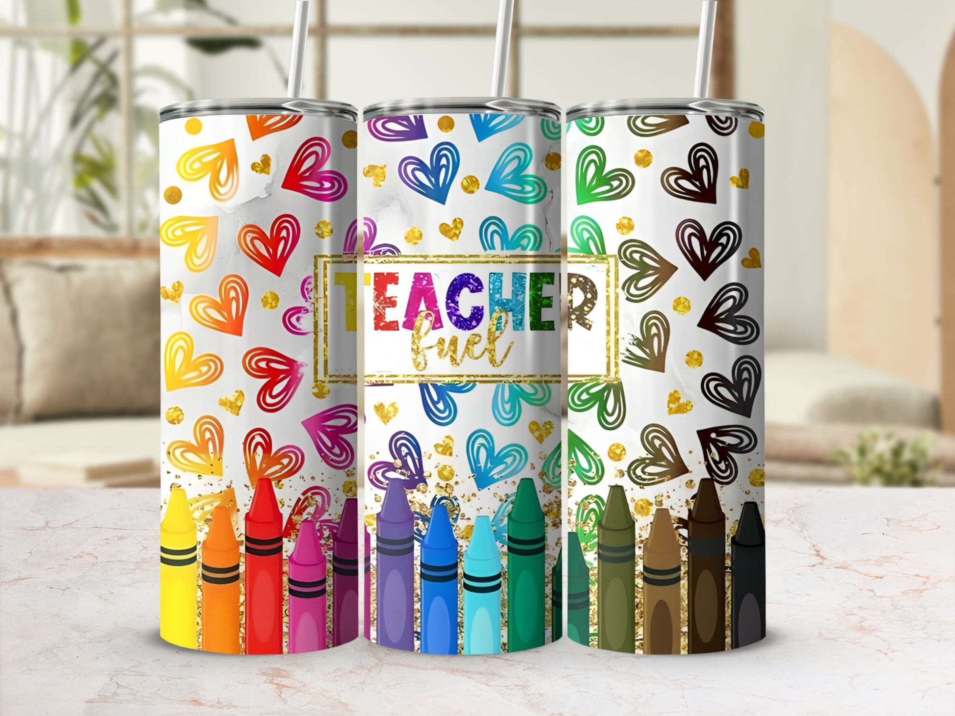 Three tumblers with colorful hearts and crayons, one saying "Teacher Fuel".
