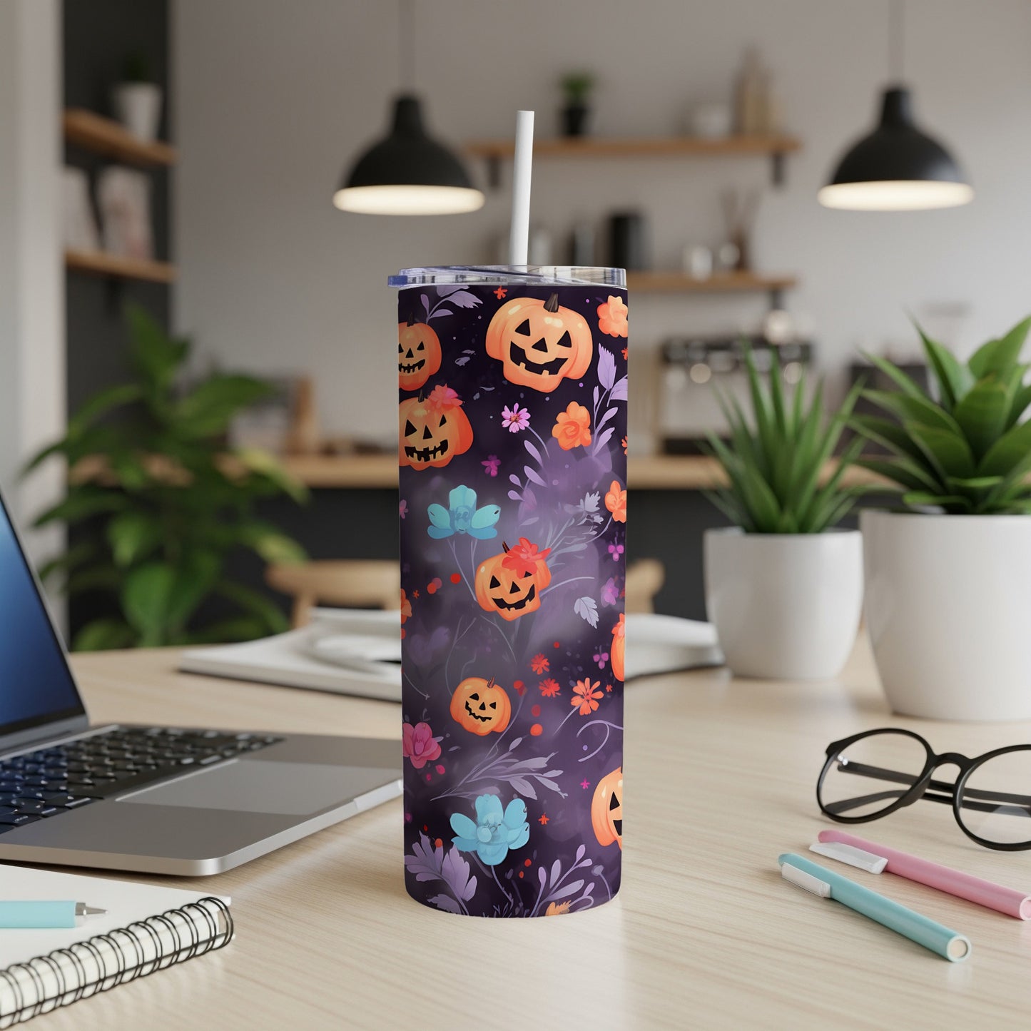 Purple tumbler with jack-o'-lanterns and floral pattern.