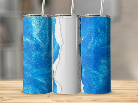 Blue glitter tumbler with torn paper effect.
