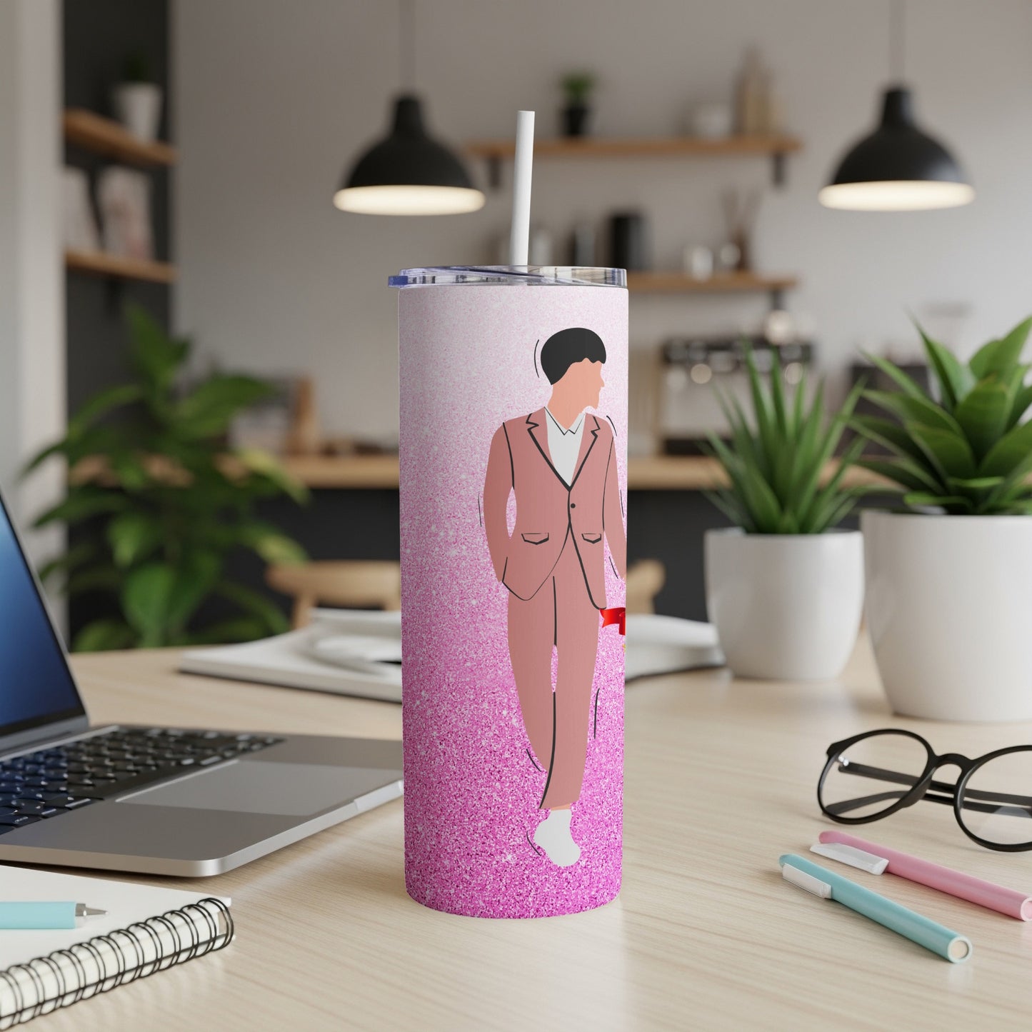 Pink glitter tumbler with stylized person in a suit and white sneakers.