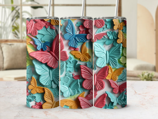 Three patterned tumblers with butterflies and floral designs.