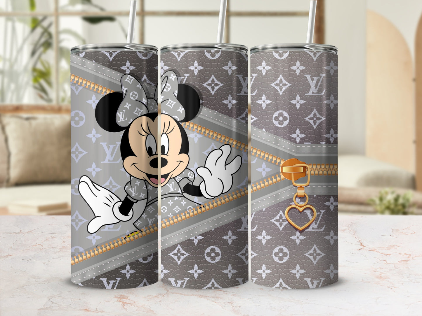 Minnie Mouse on a grey tumbler with LV-inspired pattern and gold zipper accent.