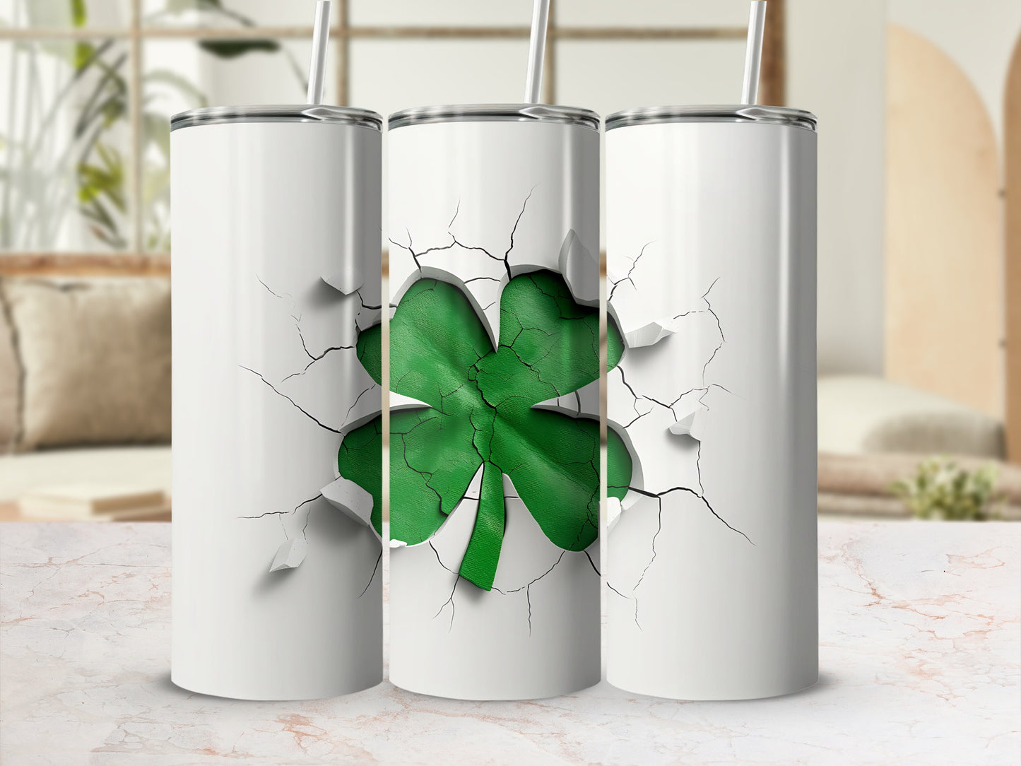 Three white tumblers with a green shamrock design breaking through the surface.