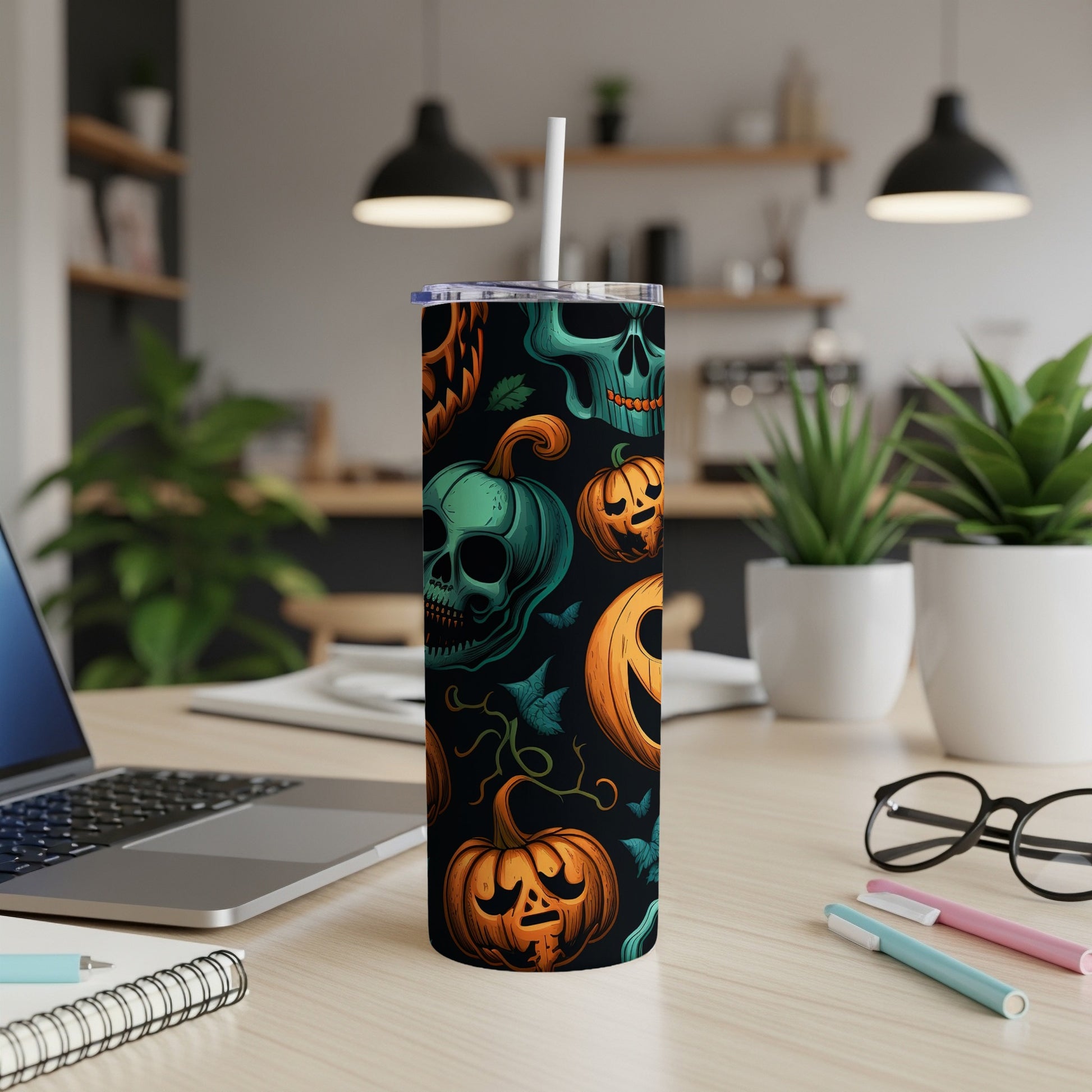 Tumbler with Halloween-themed skulls, pumpkins, and vines pattern.