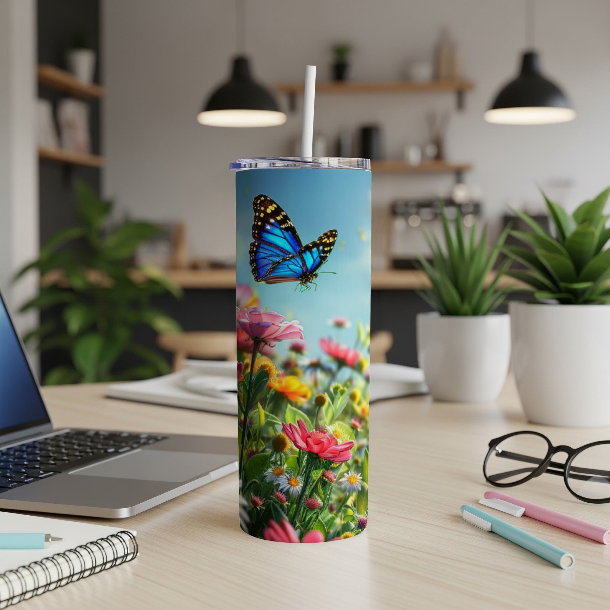 Blue butterfly in a field of flowers on a skinny tumbler.