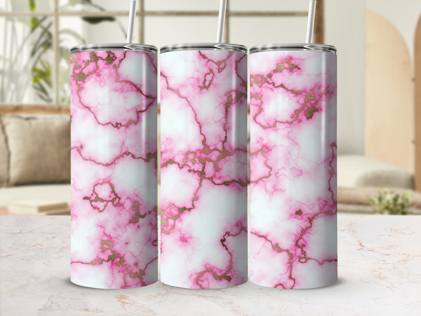 Pink and gold marble pattern on three tumblers with straws.