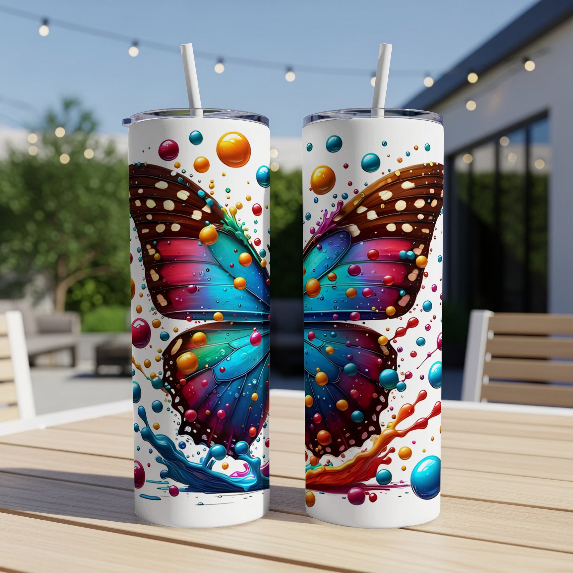 Two tumblers with colorful butterfly designs and a splash effect.