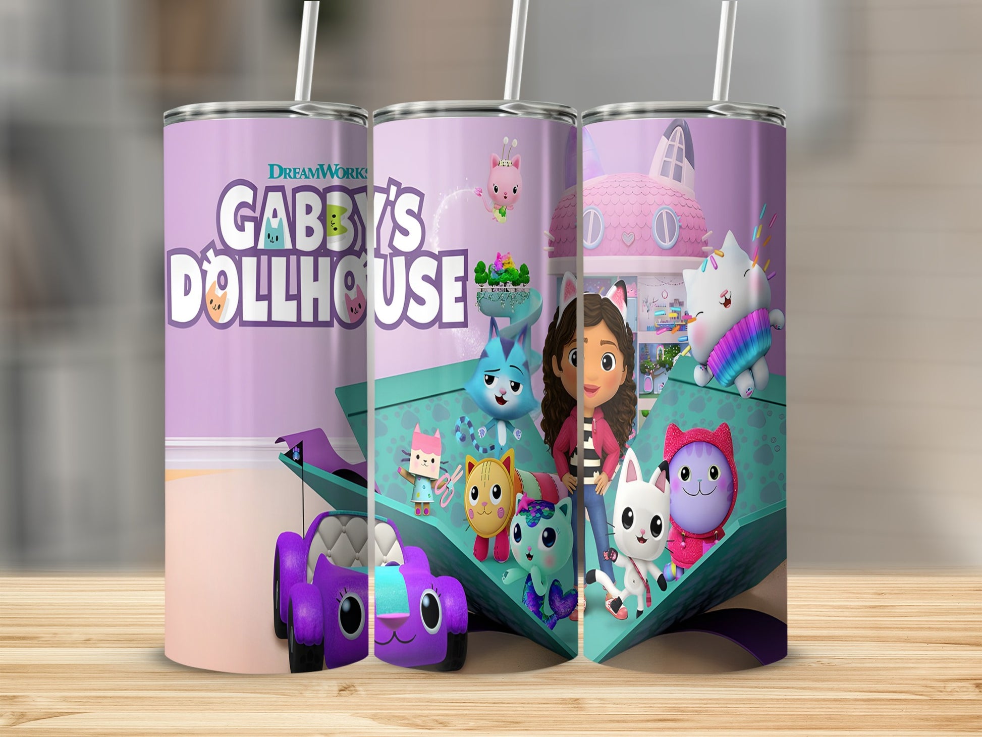 Gabby's Dollhouse characters and logos on three purple and pink tumblers.