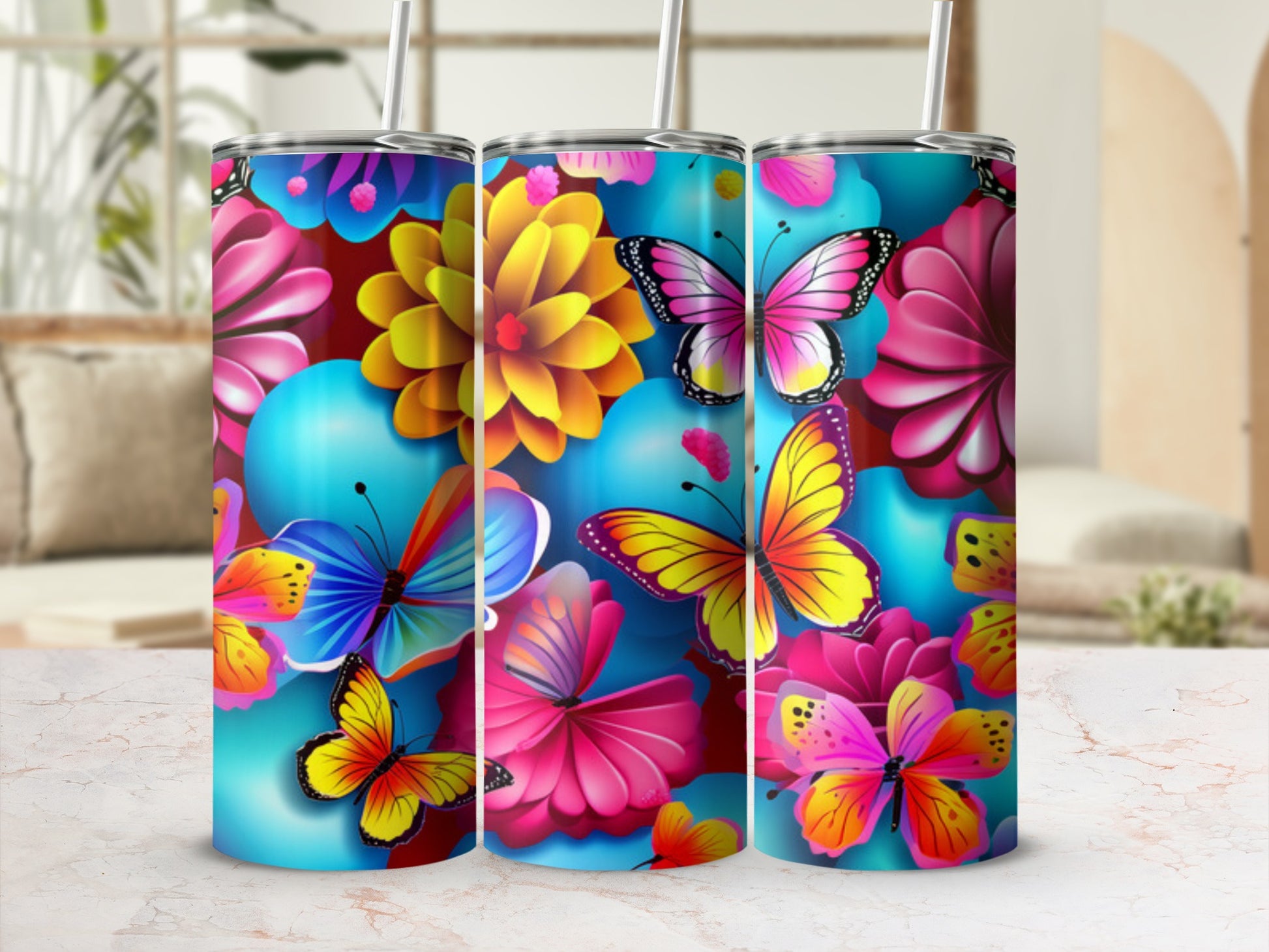 Three tumblers with vibrant butterfly and floral designs.