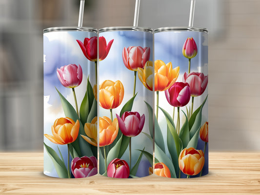 Three tumblers with watercolor tulips on a wooden surface.