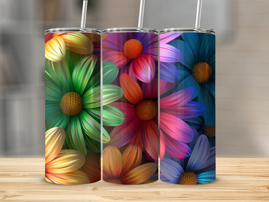 Three tumblers with colorful floral designs and straws.