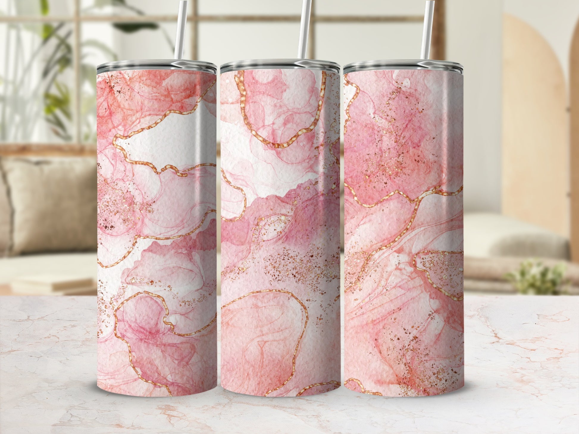 Pink marble tumbler with gold accents and straw.