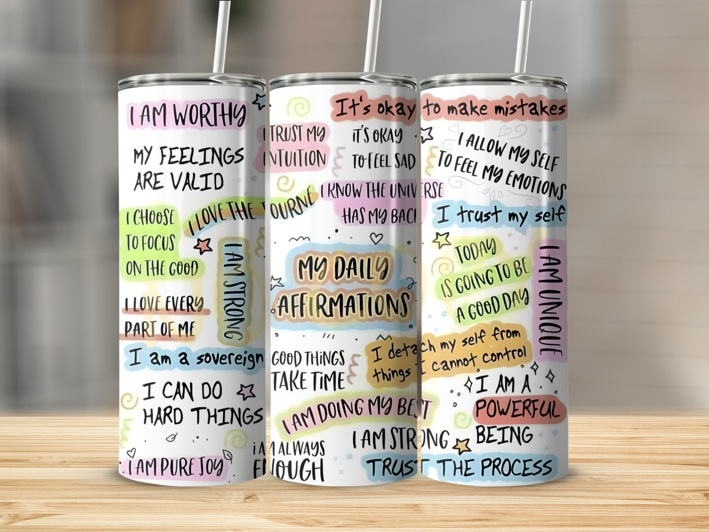 Three tumblers with affirmations about self-worth, strength, and positivity.