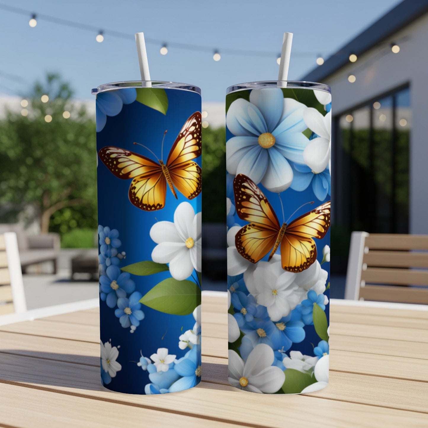 Two blue tumblers with monarch butterflies and white and blue flowers.