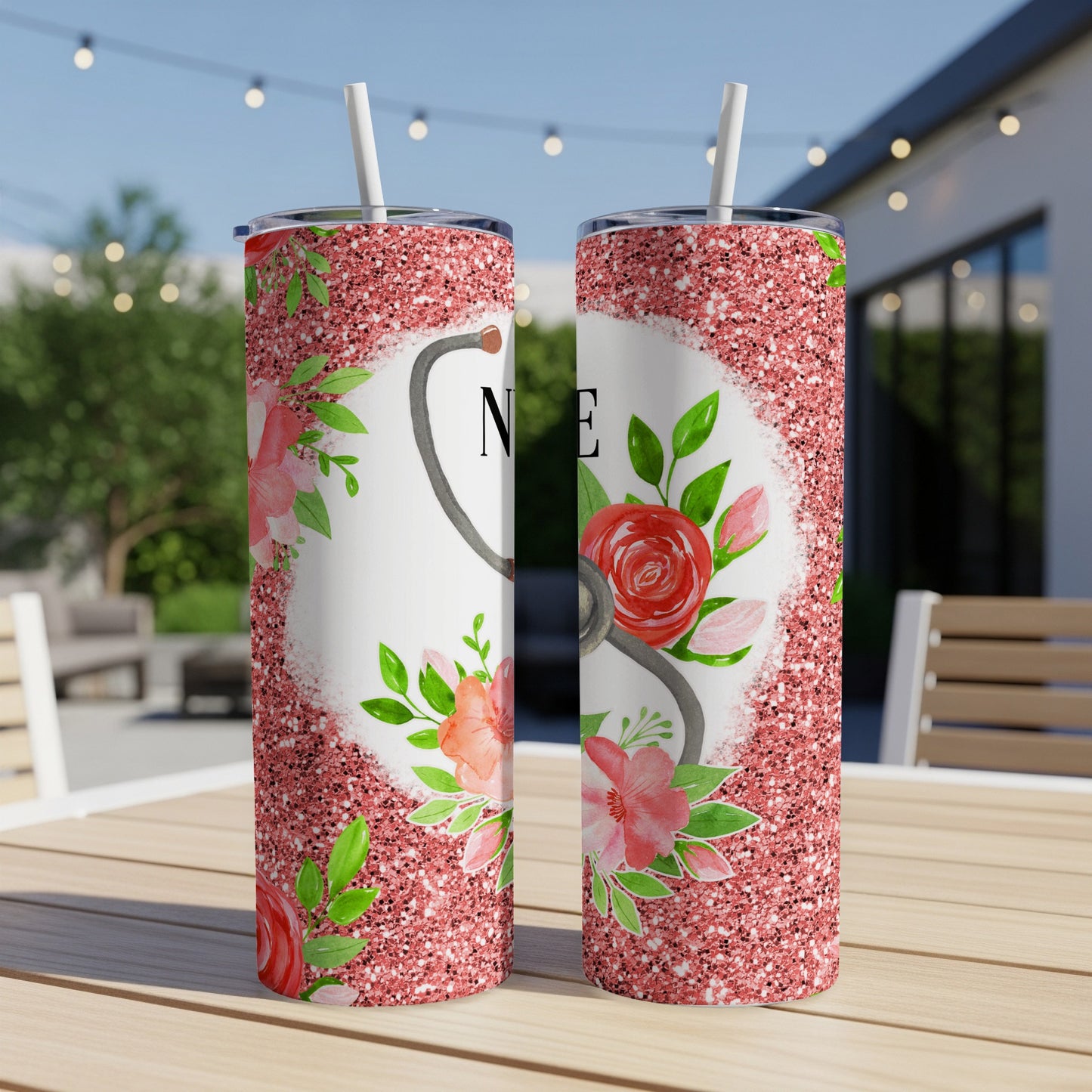 Two pink glitter tumblers with floral accents and "RN" text.