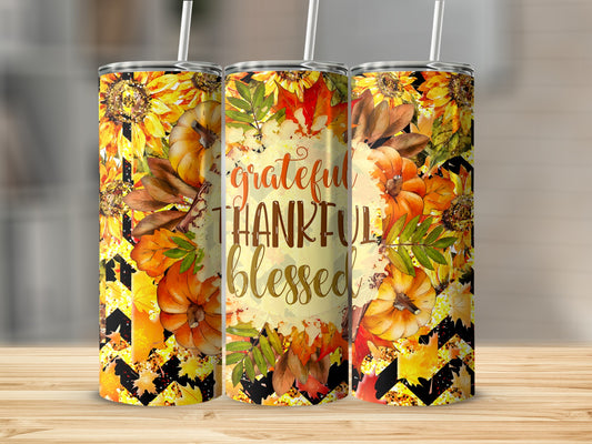 "Grateful Thankful Blessed" tumbler with pumpkins, sunflowers, and autumn leaves.