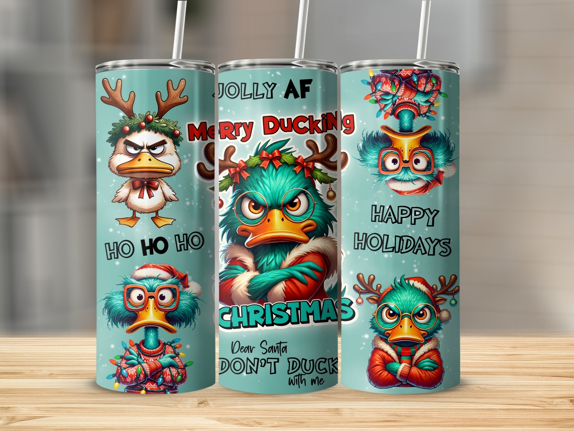 Three Christmas-themed tumblers featuring cartoon ducks with holiday messages.
